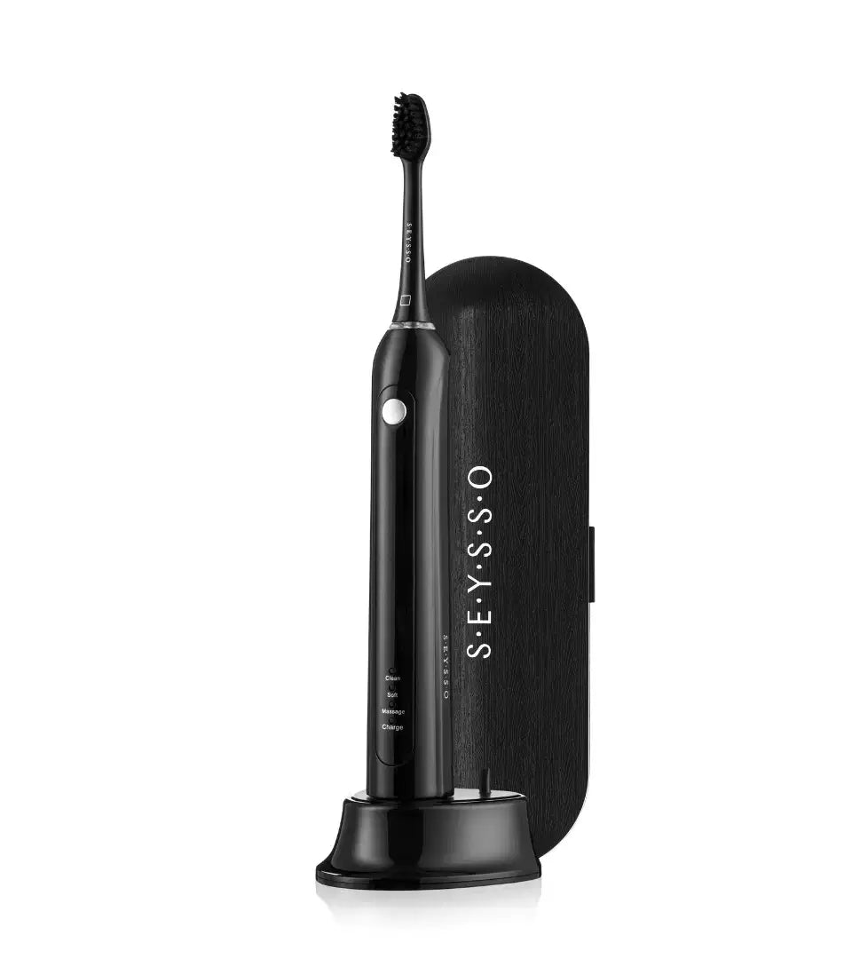 SEYSSO Basic Black Sonic Toothbrush with Travel Case on a stand next to its sleek black travel case.
