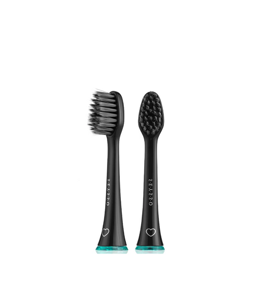 Two black toothbrush heads with bristle patterns on a white background