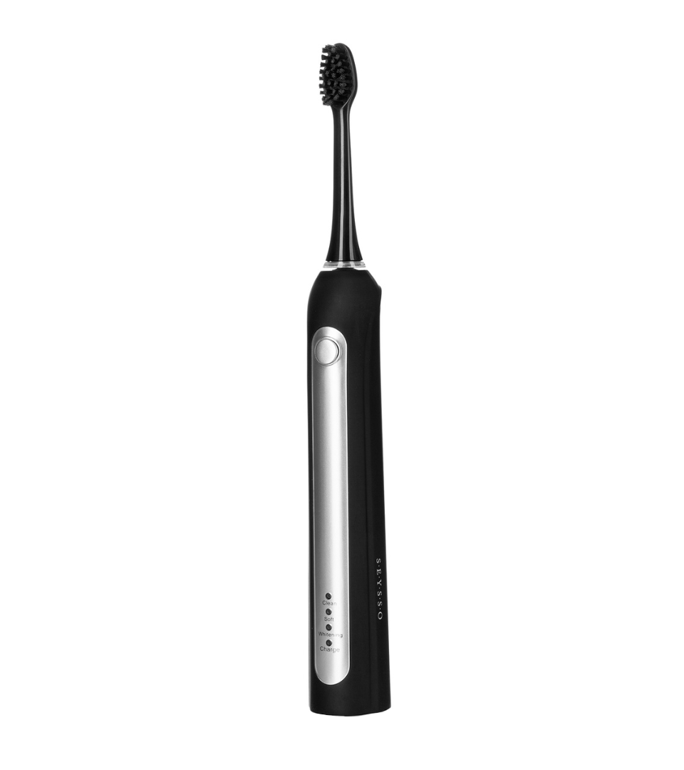 Black electric toothbrush on a white background.